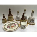 A collection of Bell's whisky bottles and contents plus an antique tea set of scalloped shape.
