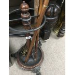 A Victorian stick stand on cast iron scrolled feet