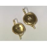 A pair of Edwardian, 18ct gold earring each set with a single diamond.Approx 3.7g