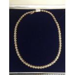 A 14ct gold necklace set with diamonds.