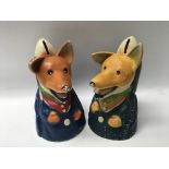 A pair of Basil Brush money boxes, one with some damage.