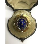 A fine quality, Victorian gold brooch, having blue enamel cabouchon set with star shape diamonds,