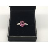 An 18ct white gold oval-cut pink sapphire and diam