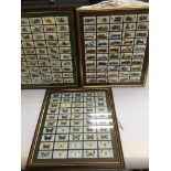 Five framed sets of cigarette cards comprising motor cars, butterflies and flowers.