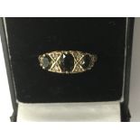 A 9ct gold ring set with three green stones.Approx P, 2.9g