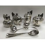 A collection of silver plated items including teapots, coffee pots, sugar shaker, ladle etc.