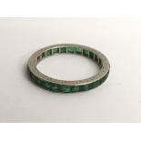 A white gold and emerald eternity ring, approx L/M