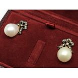 A pair of large white pearl drop earrings with dia