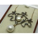 A necklace set with diamonds, pearls and seed pear