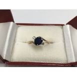 An unmarked sapphire and diamond ring.