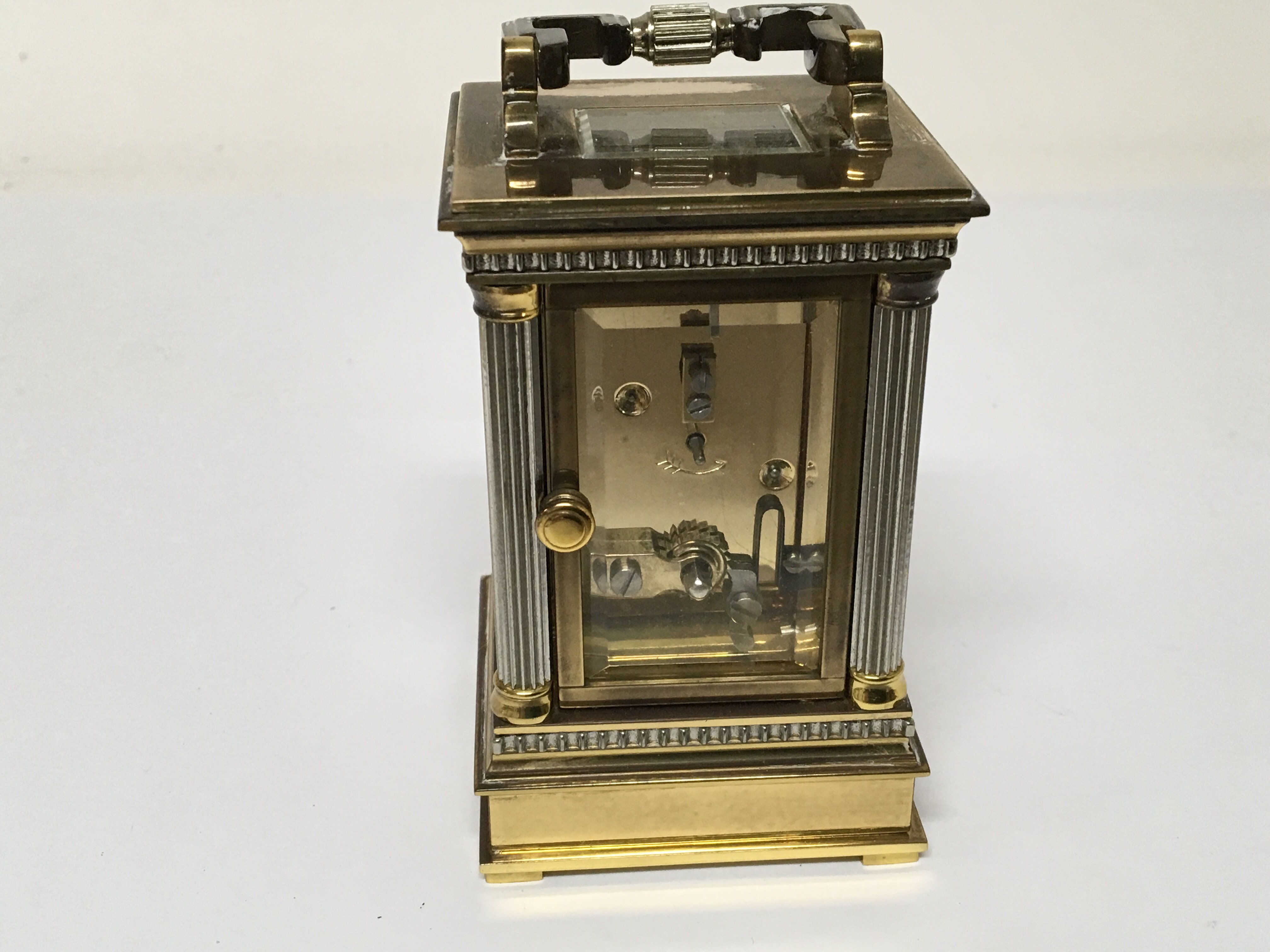 A miniature brass carriage clock with pillars to each corner the dial with Mathew Norman London - Image 2 of 2