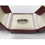 An unmarked gold ruby and diamond ring.