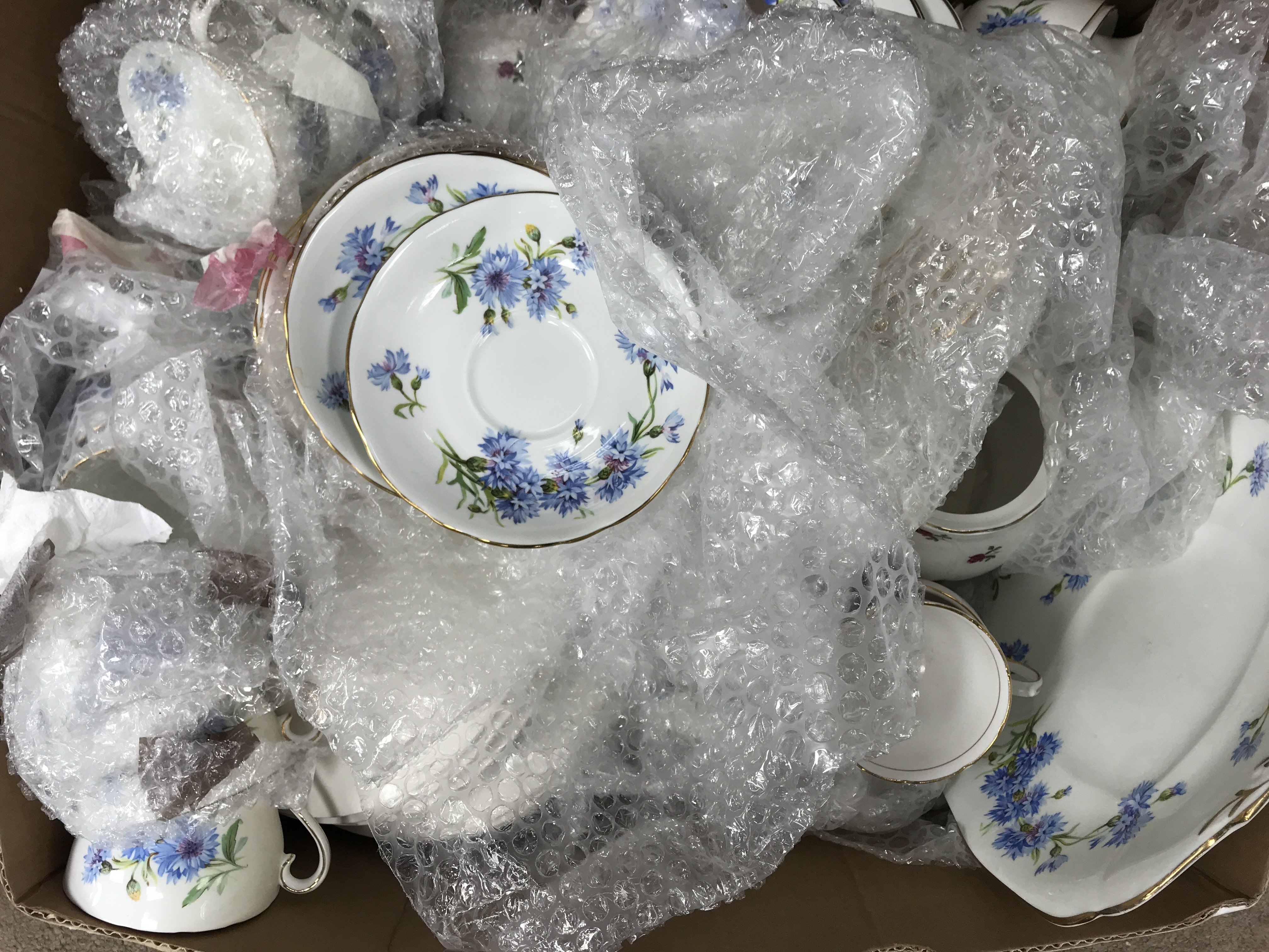 A box of vintage tea and dinner china