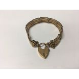 A 9carat gold gate bracelet with a padlock clasp w