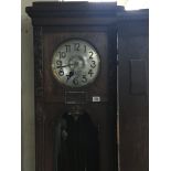 A large oak long case clock with a silvered dial v