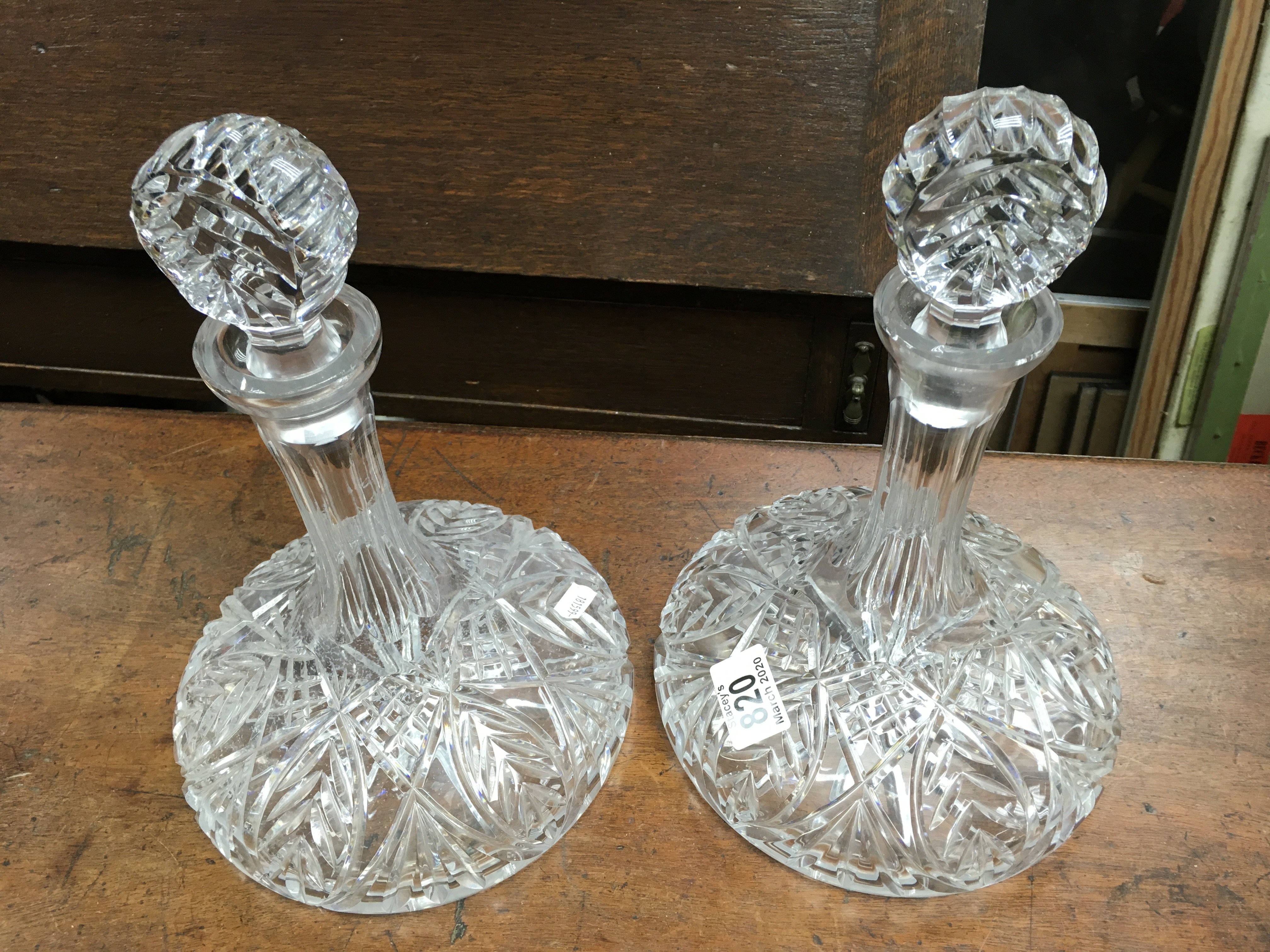 A pair of matching cut glass ships decanters