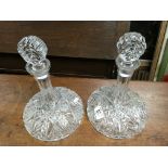 A pair of matching cut glass ships decanters