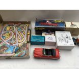 A box containing a collection of boxed tinplate re