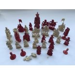 A 19th carved and stained ivory part chess set.
