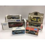 A collection of boxed die cast Ford vehicles.