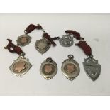 A collection of seven silver fobs