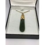 An early Edwardian jade and unmarked gold pendant on a 9ct gold chain.