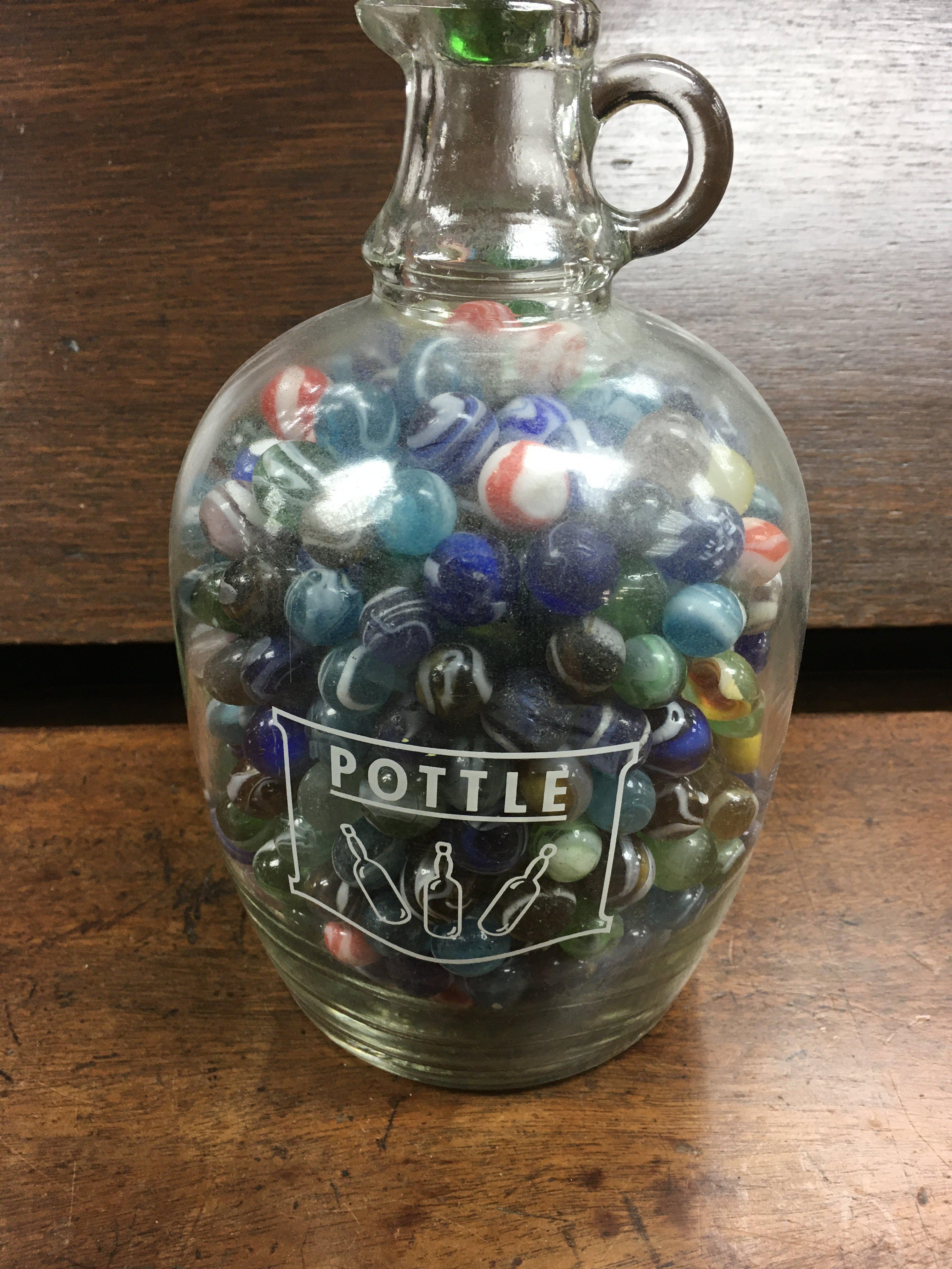 A jar of mixed early marbles.