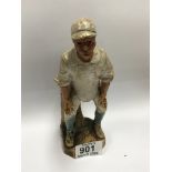 A 19thC pottery figure of a cricket player