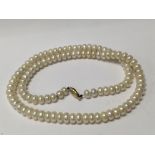 A string of cultured pearls with 14ct clasp