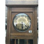 A 1920s oak longcase clock with a hammered finish