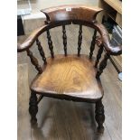 A 19th century Elm and Beech wood captains chair with turned supports.