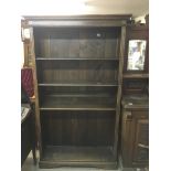 A large oak open fronted bookcase.