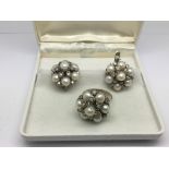 A pair of silver earrings set with cultured pearls and CZ stones together with a matching ring,