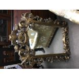 A reproduction gilt mirror.