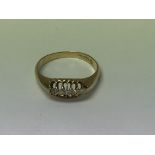 A 18 ct gold ring inset with five diamonds