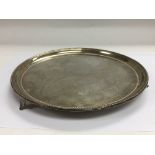 A Victorian tri footed circular silver tray By Jam