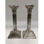 A pair of Corinthian column candlesticks, approx 2