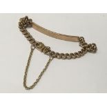 A gold bar bracelet with safety chain