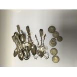 A collection of silver spoons and silver coins
