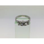 An 18ct white gold ring set with three diamonds, a