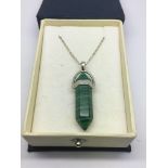 A malachite pendant on a silver chain.