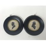 A pair of silhouettes in round frames of a Victori
