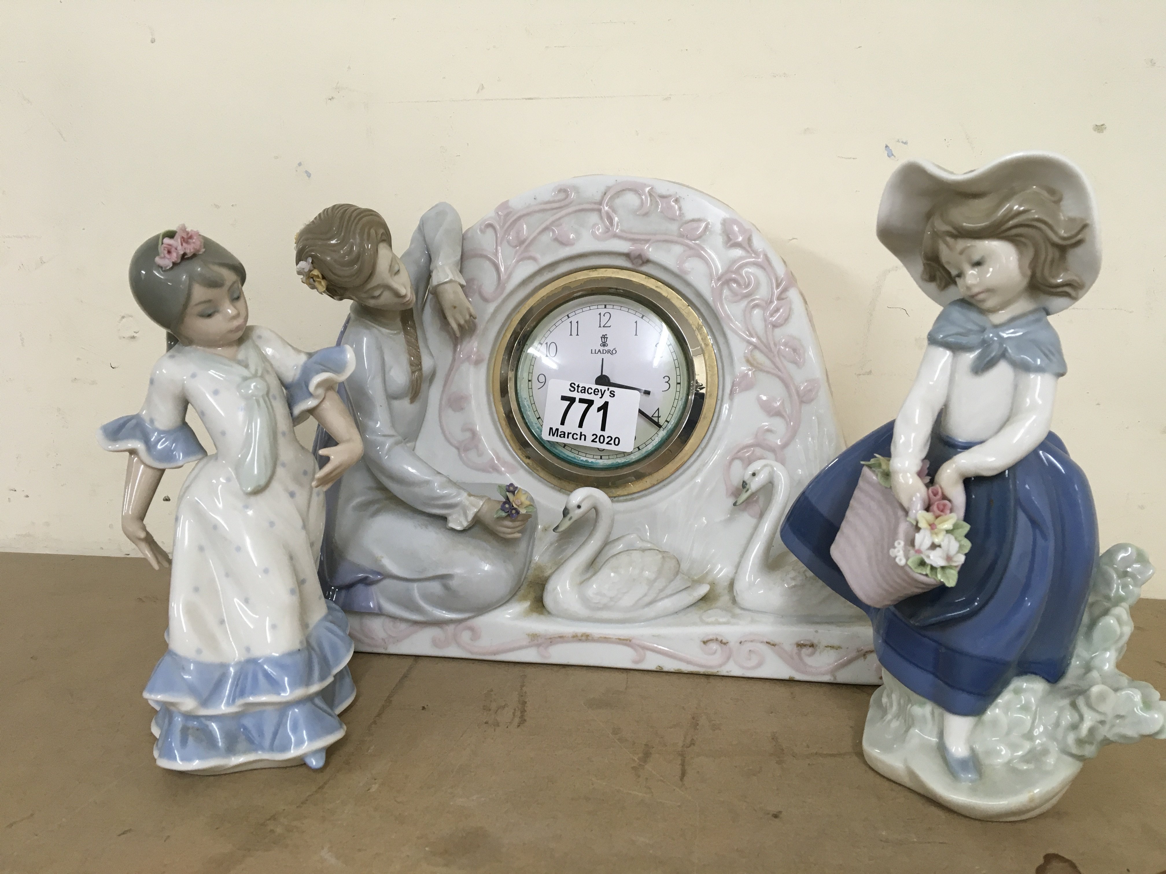 A Lladro porcelain clock figurine and 2 additional