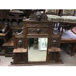 A large carved oak over mantle mirror