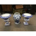 2 Portuguese blue and white pottery urns and 1 Chinese porcelain pot.