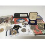 A collection of commemorative coins including some silver proof.