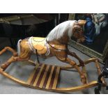 A large hand carved wooden rocking horse by George