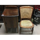 A small Edwardian inlaid bedside cabinet and a rattan bedroom chair.