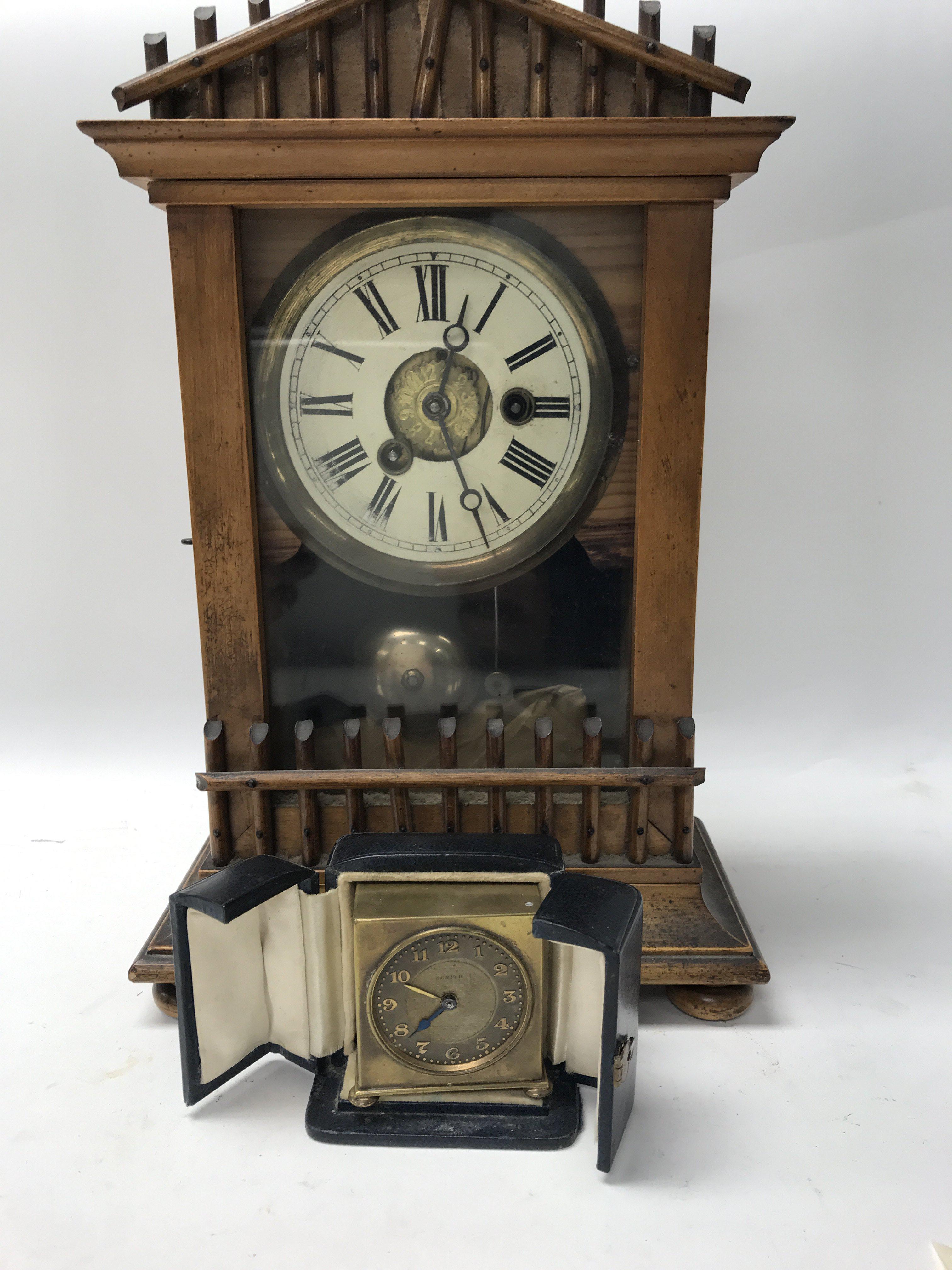 A small zenith brass travel clock in original case