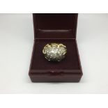 An unmarked gold dome shaped diamond cluster ring,